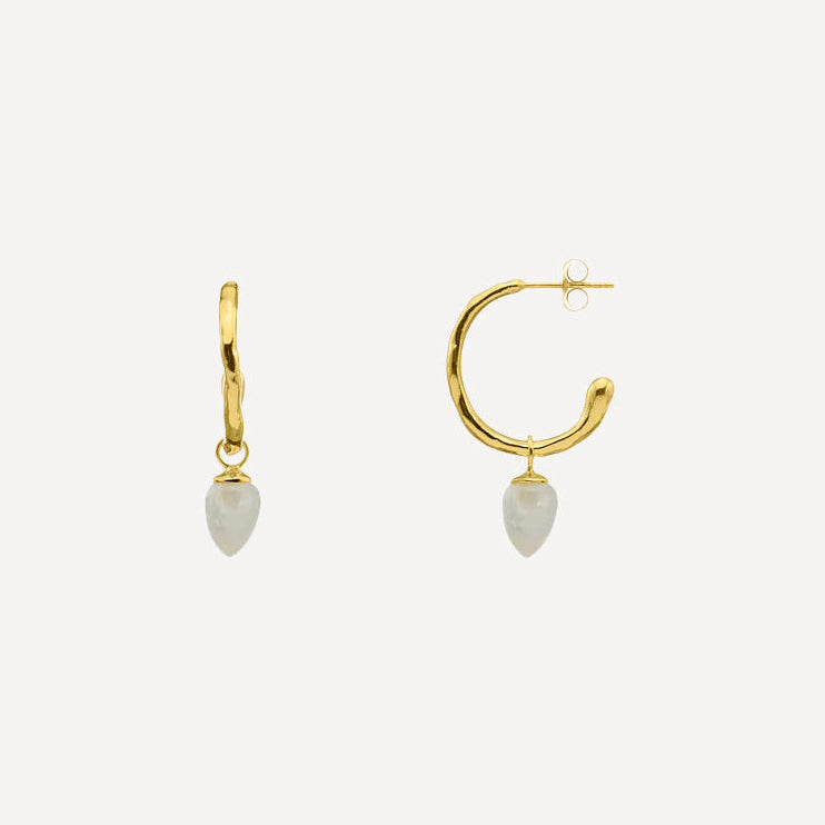 Gold hoop earrings with teardrop-shaped white stones on a light gray background