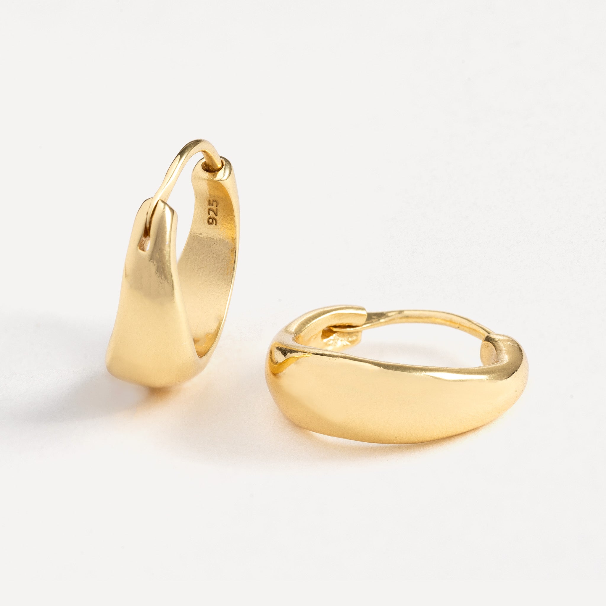 Huggie features a handcut natural round shape and is crafted from sterling silver or 18ct gold vermeil.