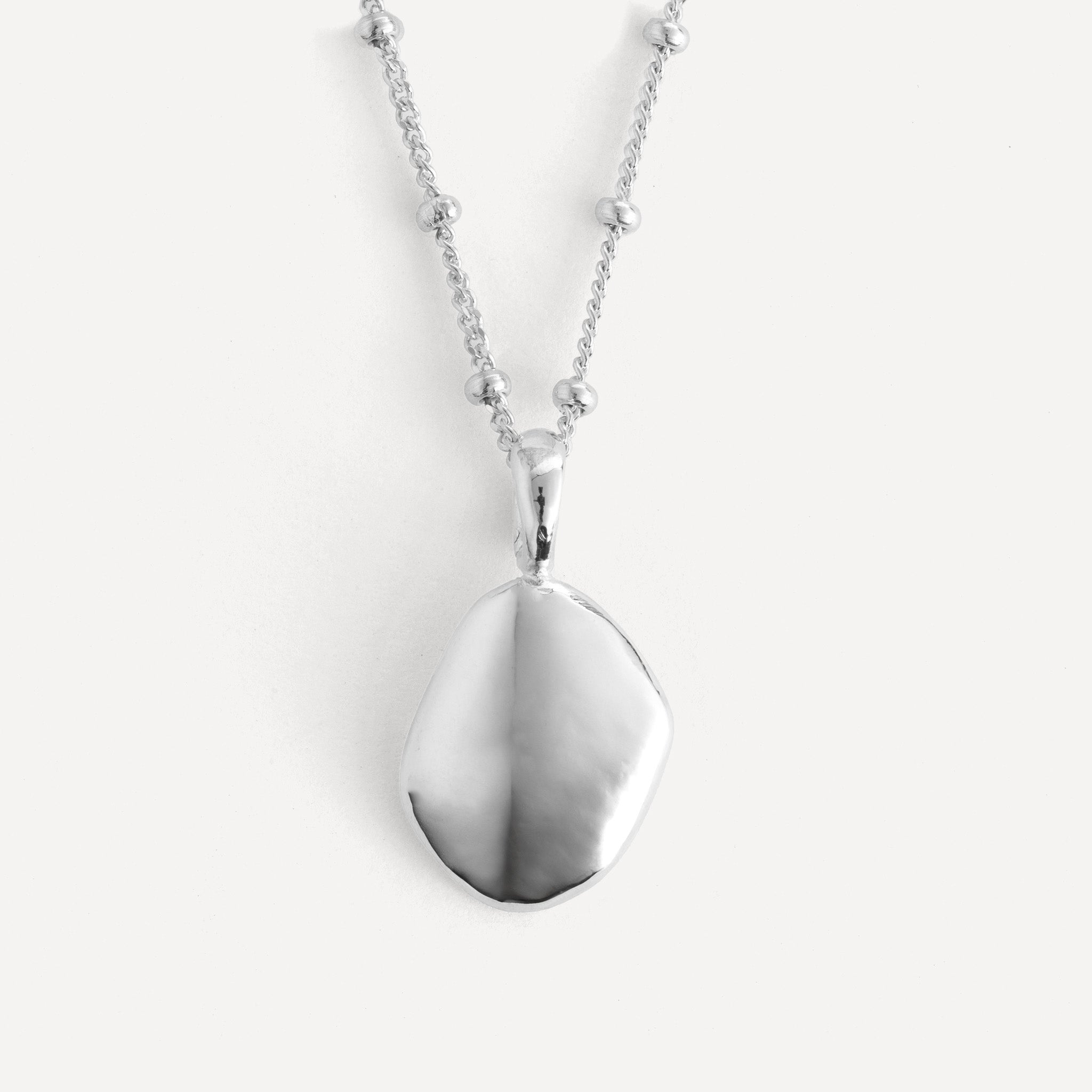 Pendant features a handcut natural pebble shape and is crafted from sterling silver or 18ct gold vermeil.