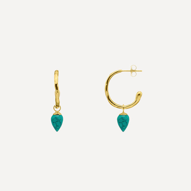 A pair of gold hoop earrings with teardrop-shaped turquoise gemstones, shown against a light gray background.